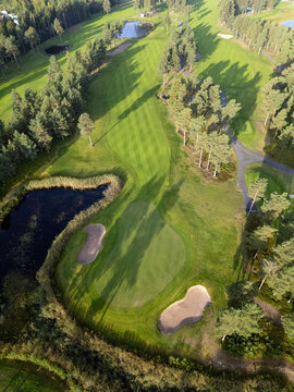 Aerial view of Virpiniemi Golf course featuring lush green fairways, sand bunkers, and surrounding pine forests in Oulu, Pohjois-Pohjanmaa, Finland.