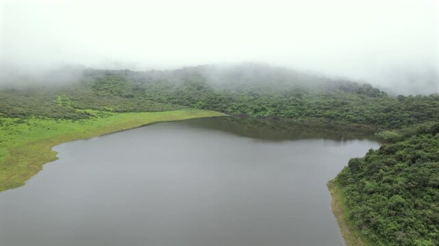 4K drone aerial view of Yala Provincial Park in Jujuy, Argentina. Misty mountain lakes surrounded by lush Yungas forests and dense green vegetation in a spectacular Andean landscape.