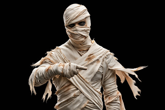 Ancient Egyptian mummy wrapped in tattered bandages reaching with pointed hand for Halloween