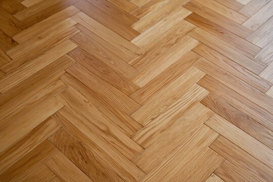 The Parquet Floor in Warm Walnut Tones with Intricate Herringbone Pattern