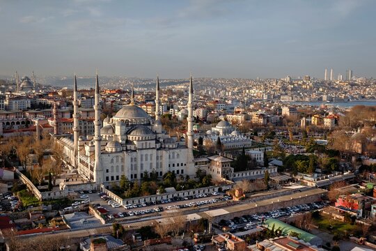 Aerial view of the Sultan Ahmed Mosque, also known as the Blue Mosque, with its iconic minarets and domes surrounded by the historic urban landscape of Fatih, Istanbul, Turkey.