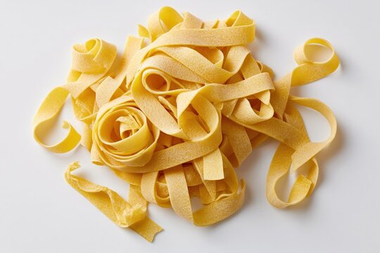 The Golden Pasta Ribbons Closeup of Uncooked Noodles on White
