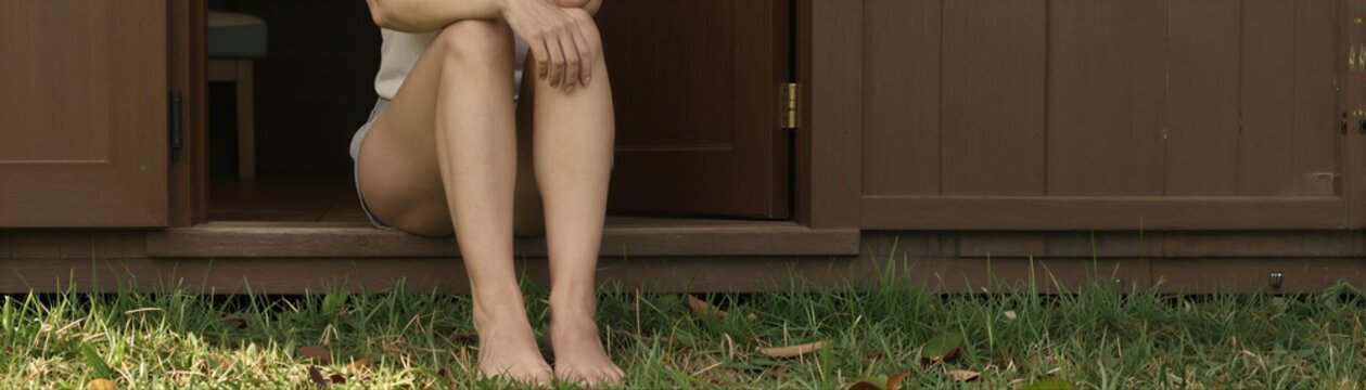 Captures Lower Half Of Person Sitting On To Wooden Porch Steps Leading Open Door With Brown Panels Part Rustic Cabin Shed In Rural