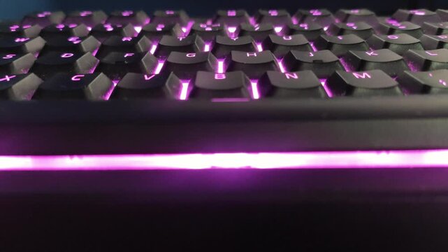 Dynamic spectrum of light cycling through mechanical keyboard illumination in studio setting.