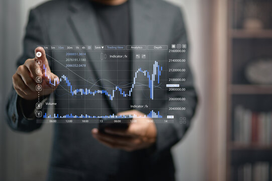 Businessperson Analyzing Financial Data On Transparent Digital Screen In Office
