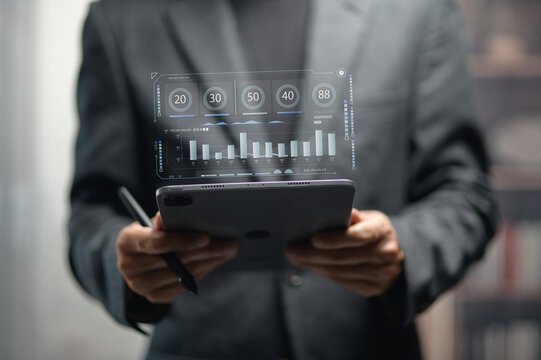 Business Professional Analyzing Digital Data on Tablet in Modern Office