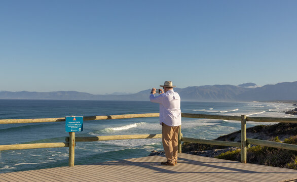 adult man wearing hat exploring beautiful Walker Bay Nature Reserve, Gansbaai, South Africa