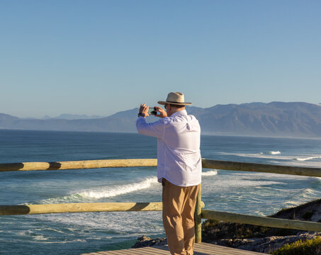 adult man wearing hat exploring beautiful Walker Bay Nature Reserve, Gansbaai, South Africa