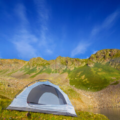 touristic camp stay among green mountains, summer mountain travel scene © Yuriy Kulik