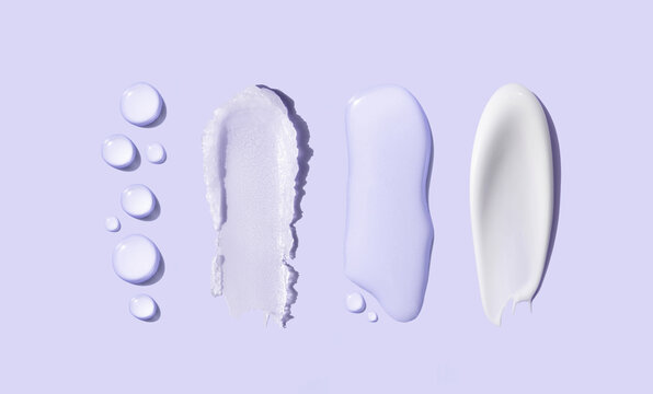 samples of cosmetic care products smear of cream and gel texture on a light background