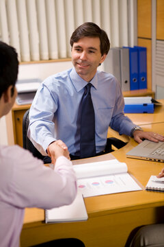 Business executives shaking hands