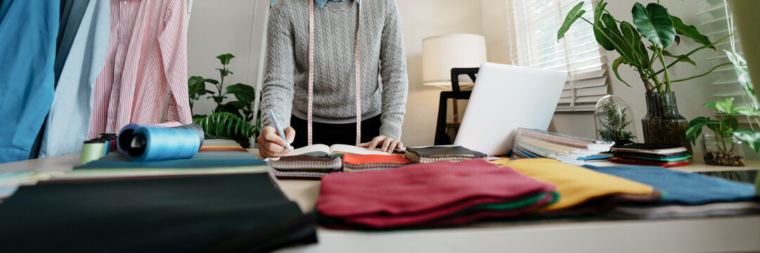 Fashion designer atelier stylish artist or creative designer drawing on sketch book with new project design