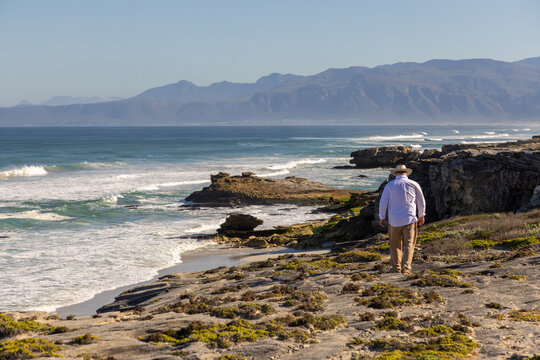 adult man wearing hat exploring beautiful Walker Bay Nature Reserve, Gansbaai, South Africa