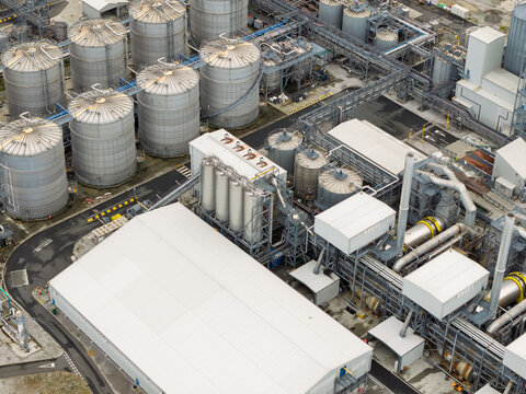 Aerial view of an industrial facility with large storage tanks, processing units, and complex piping systems in the United Kingdom.