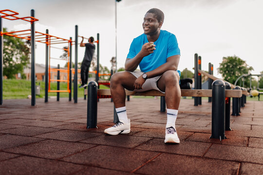 Athlete relaxing at outdoor gym after workout