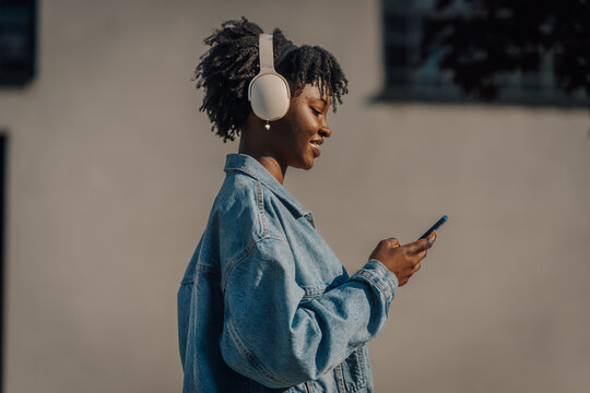Young african american woman enjoying music experience urban