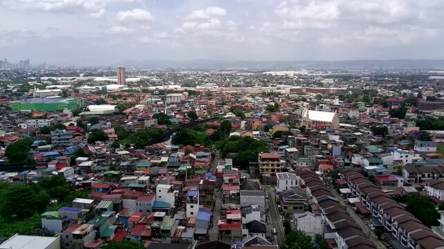 Dolly In Wide Establishing Shot of Taguig City in Metro Manila with Landscape of Houses and Buildings with Airplane Landing in the Distance