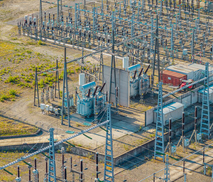 Aerial view of high voltage power transformers and electrical substation infrastructure with switchgear and transmission equipment, Saulce-sur-Rhone, Auvergne-Rhone-Alpes, France.