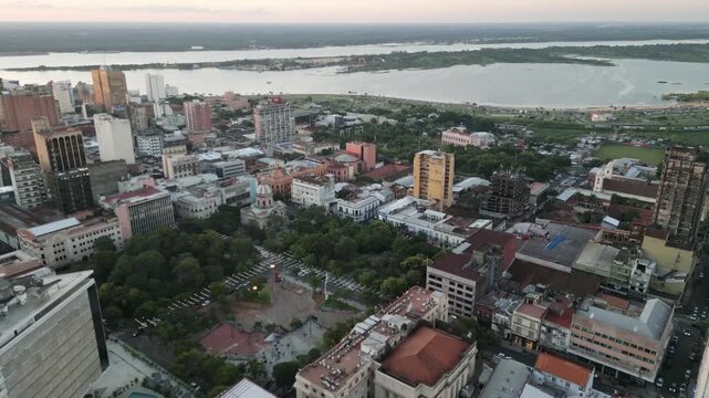 Aerial drone perspective of central Asuncion city streets and urban cityscape at twilight.