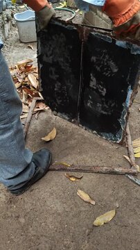 Detaching Old Metal Sheet from Iron Frame in Workshop