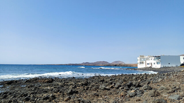 Coastal view of the Caleta de Caballo, a small fishing and surfing village located on the northwest coast of Lanzarote, Canary Islands, Spain.