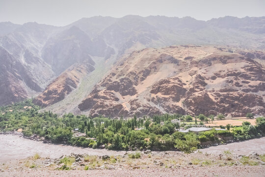 Afghanistan from the Tajikistan side. Mountain slopes and the bank of the Panj River, which forms the border between the two countries