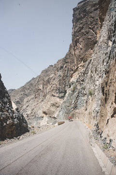 An asphalt road on the Pamir Highway in the Panj River Valley along the border of Afghanistan and Tajikistan, a road among rocky mountains