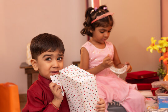 Children enjoying gift opening in a festive setting