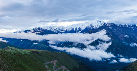 Fototapeta premium Dramatic Mount Gongga landscape surrounded by a sea of clouds over the valley, western Sichuan, China