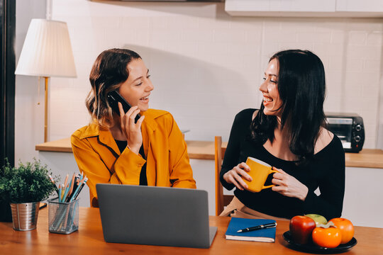 Portrait of military mother helping teen daughter with homework and eating lunch