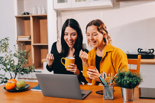 Portrait of military mother helping teen daughter with homework and eating lunch