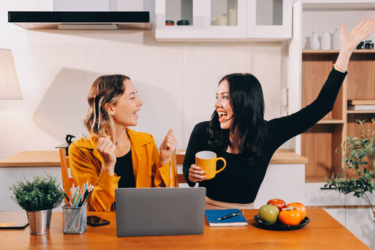 Portrait of military mother helping teen daughter with homework and eating lunch