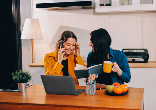 Portrait of military mother helping teen daughter with homework and eating lunch