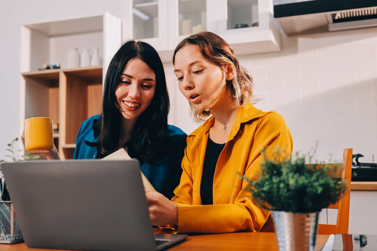 Portrait of military mother helping teen daughter with homework and eating lunch