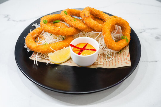 Crispy Fried Calamari with Dipping Sauce and Golden Brown Breading