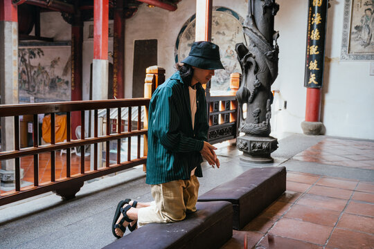 Man kneeling in temple worshipping and praying