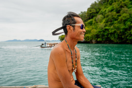 Smiling man enjoying boat ride in tropical ocean
