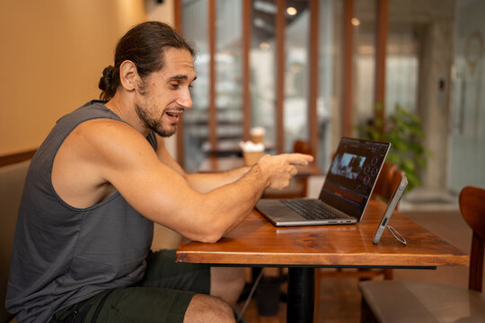 Freelancer man working video editing on laptop in cafe