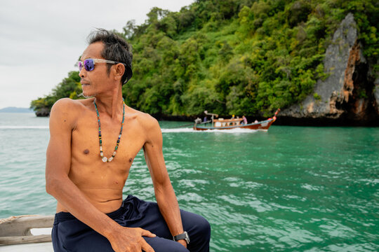 Thai man enjoying tropical boat trip in andaman sea