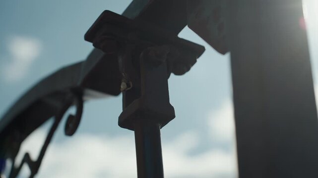 Close up of metal bracket and bolt assembly on industrial structure with soft lighting. focus remains steady highlighting texture details like rust spots or weld lines against blurred
