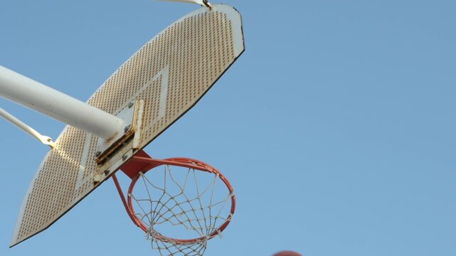 Basketball swishing through hoop and net