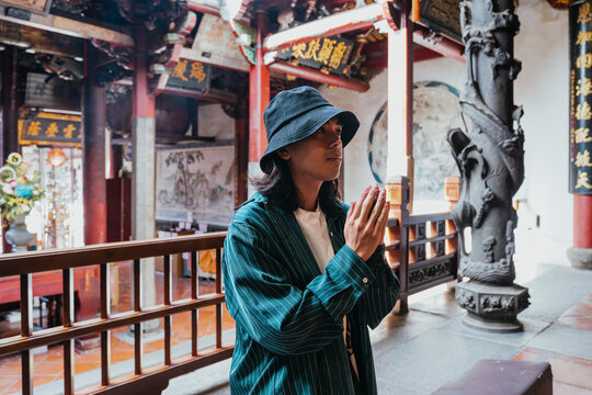 Young person praying in a buddhist temple
