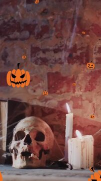 Animation of halloween pumpkins over candles and skull on brick wall background