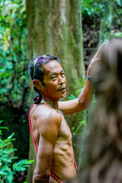Indigenous man guiding through tropical rainforest