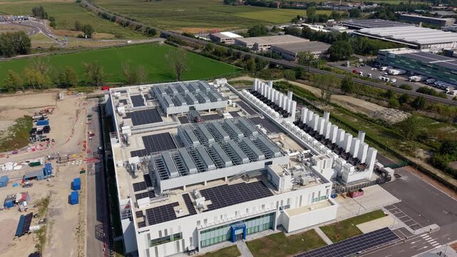 Aerial view of a large-scale data center campus near Milan, Italy, showing extensive digital infrastructure associated with hyperscale computing, data processing, storage and cloud services.