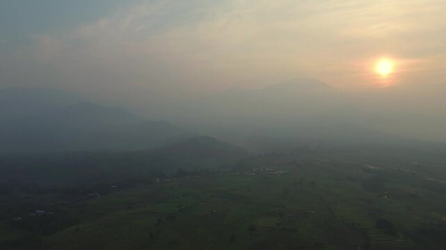 the beauty of the foggy morning panorama with sunrise and rice fields in Bengkulu, indonesia, asia