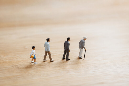 AI generated miniature people representing childhood adulthood old age aging progression longevity health span life cycle human development concept