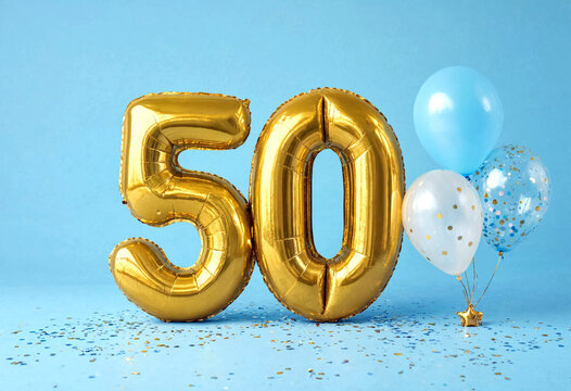 Golden number fifty balloon with colorful confetti balloons for birthday anniversary or celebration event setup