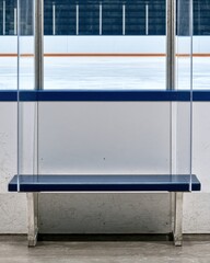 Fototapeta premium Empty ice hockey rink view through protective glass with blue trim for sports design poster background
