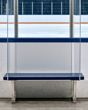 Empty ice hockey rink view through protective glass with blue trim for sports design poster background
